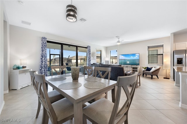 dining area featuring light tile patterned floors and ceiling fan