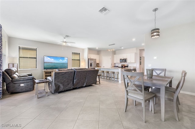 tiled dining area featuring ceiling fan