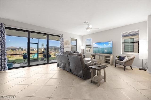 tiled living room with ceiling fan