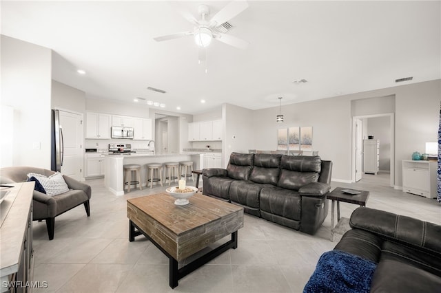 tiled living room with ceiling fan