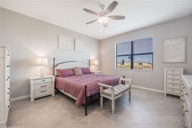 tiled bedroom featuring ceiling fan