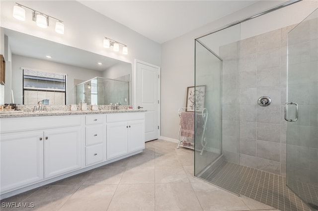 bathroom featuring tile patterned flooring, vanity, and walk in shower