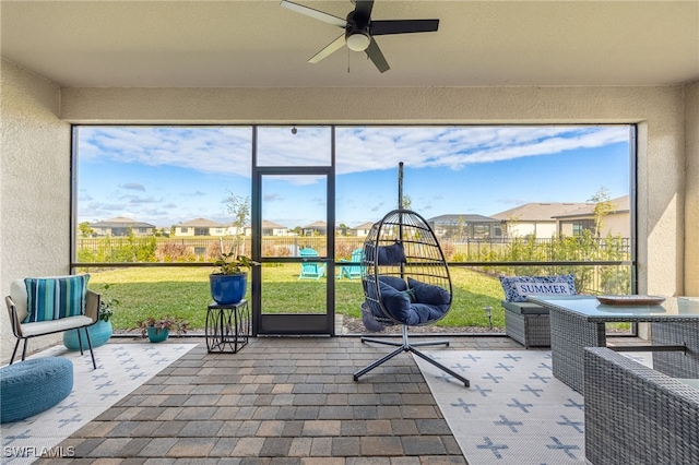 sunroom with ceiling fan