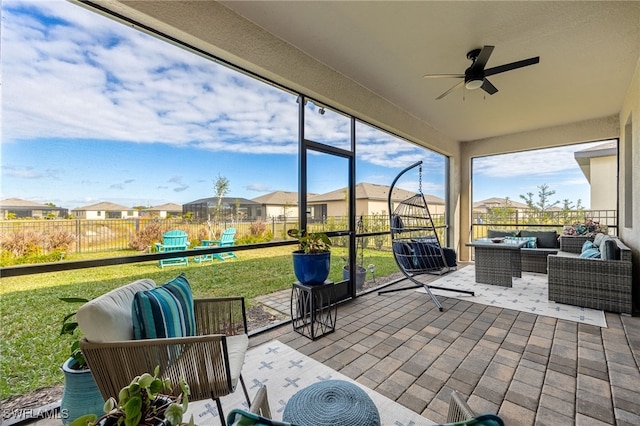 sunroom featuring ceiling fan