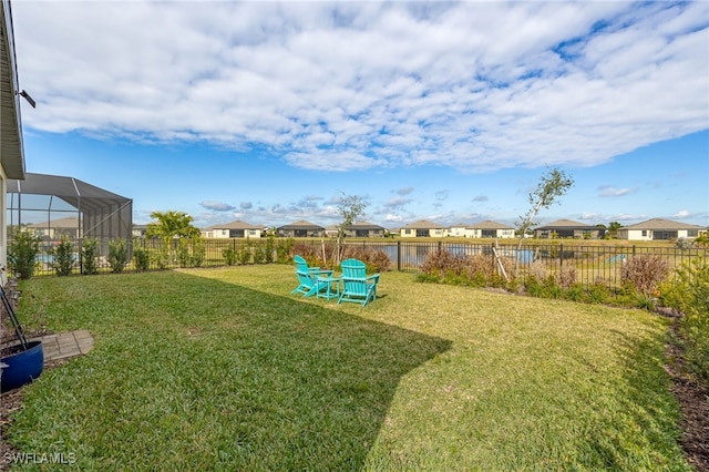 view of yard with glass enclosure