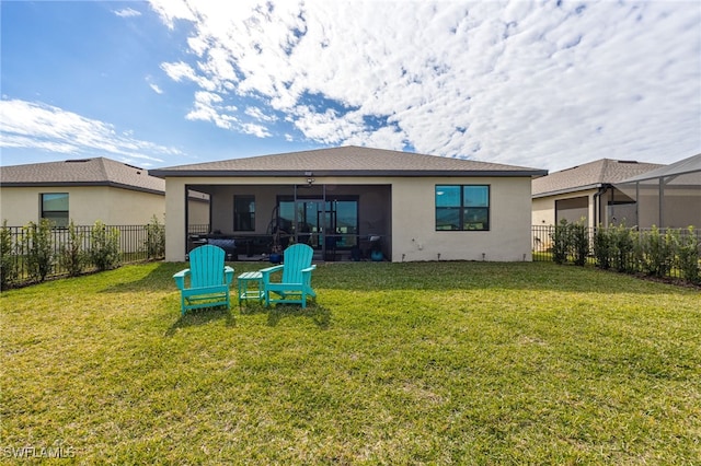 back of house with a sunroom and a yard