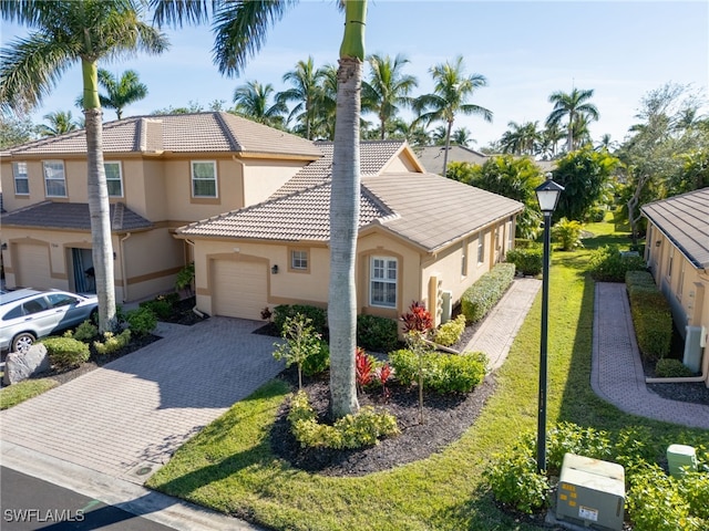 view of front of property with a front yard and a garage