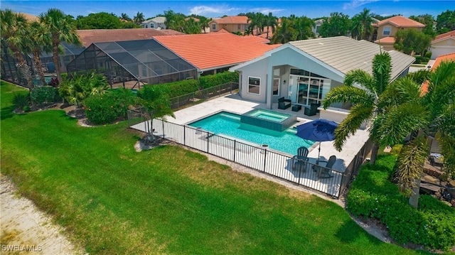 view of swimming pool with a lawn, a patio area, a fenced backyard, and a pool with connected hot tub