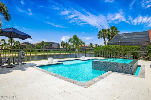 view of swimming pool with glass enclosure, an in ground hot tub, a water view, fence, and a patio area