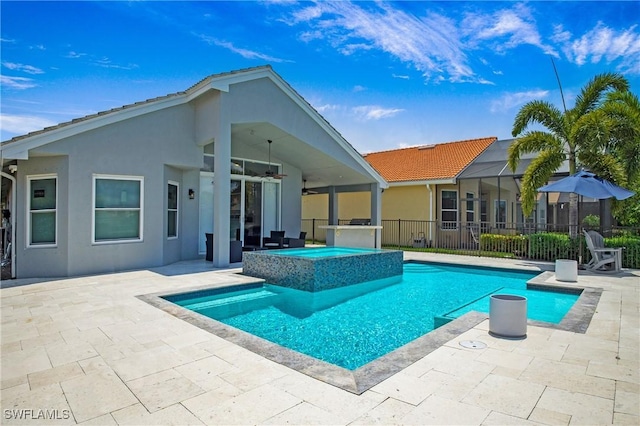 view of pool with ceiling fan, an in ground hot tub, a patio area, and fence