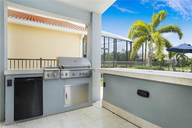 view of patio featuring area for grilling and fence