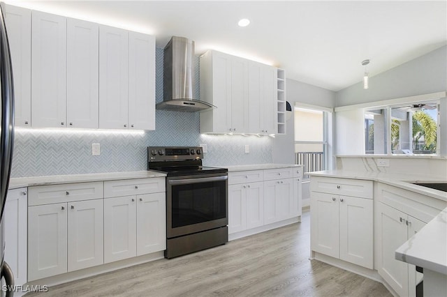 kitchen featuring white cabinets, stainless steel electric range oven, light countertops, wall chimney range hood, and open shelves