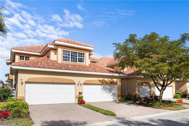 mediterranean / spanish house with a garage