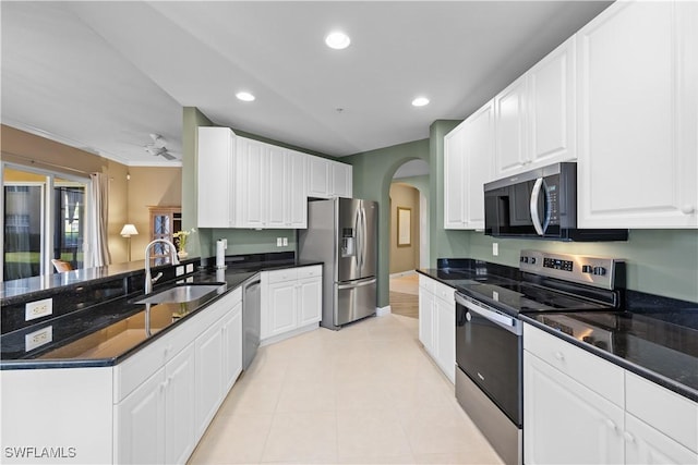 kitchen featuring dark stone countertops, sink, white cabinets, and appliances with stainless steel finishes