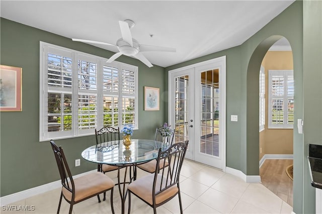 dining space with ceiling fan, light tile patterned floors, and french doors