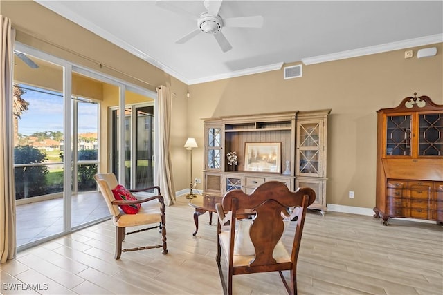 sitting room with ceiling fan and crown molding