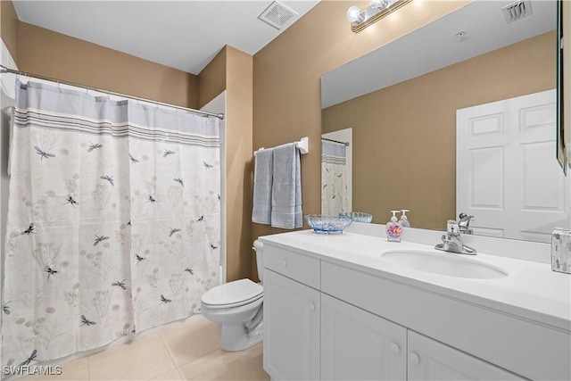 bathroom featuring toilet, vanity, and tile patterned floors