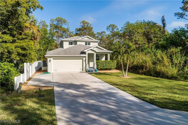 view of front of property featuring a garage and a front yard