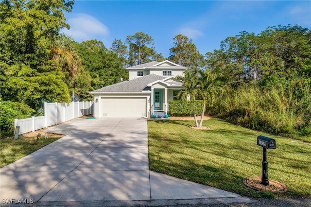 view of front of home with a front yard and a garage