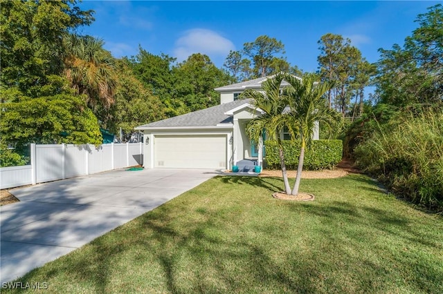 view of front of property featuring a front lawn and a garage