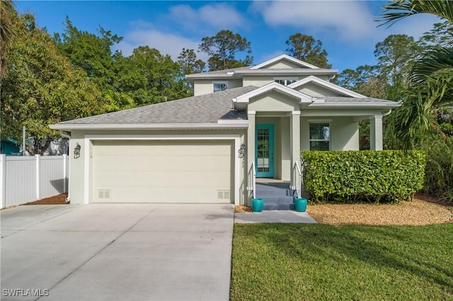 view of front of property with a front yard and a garage