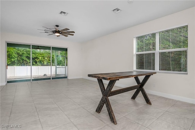 interior space featuring a wealth of natural light, ceiling fan, and light tile patterned flooring