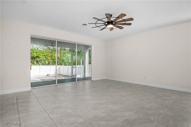 spare room featuring ceiling fan and light tile patterned flooring