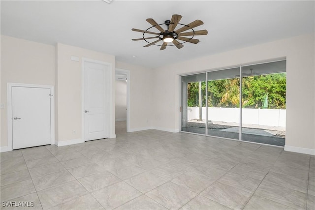 tiled empty room featuring ceiling fan