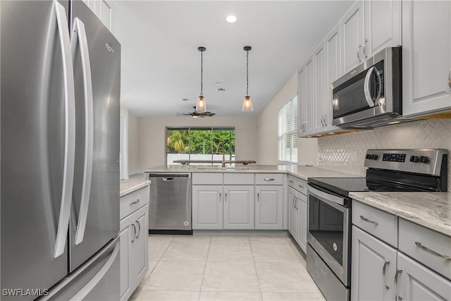 kitchen featuring decorative backsplash, appliances with stainless steel finishes, ceiling fan, sink, and light tile patterned floors