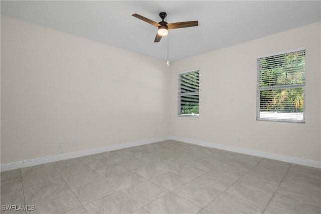 tiled empty room with ceiling fan