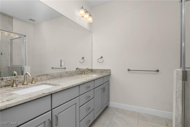 bathroom with tile patterned floors, vanity, and a shower with shower door