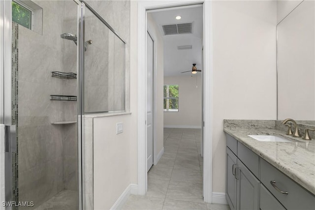 bathroom with walk in shower, vanity, tile patterned floors, and ceiling fan