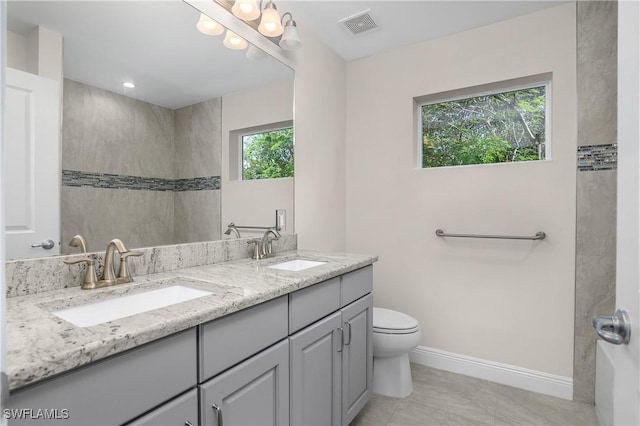 bathroom with tile patterned flooring, vanity, and toilet