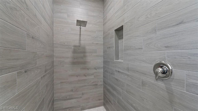 bathroom with a tile shower