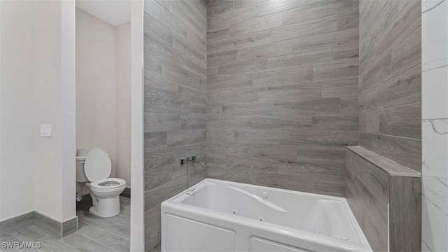 bathroom featuring toilet and a tub to relax in