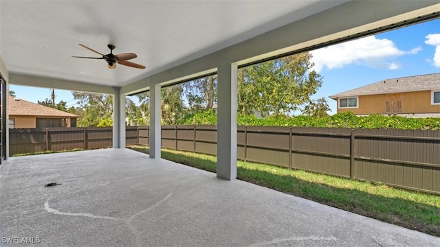 unfurnished sunroom featuring ceiling fan and a healthy amount of sunlight