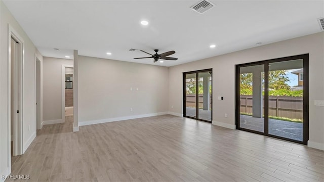 unfurnished room featuring baseboards, light wood finished floors, visible vents, and recessed lighting