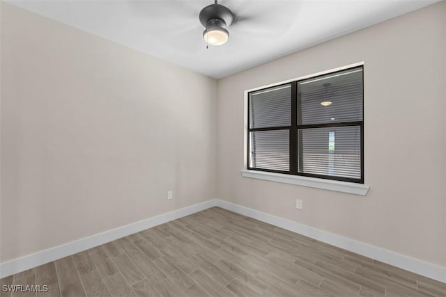 unfurnished room with ceiling fan, baseboards, and wood finished floors