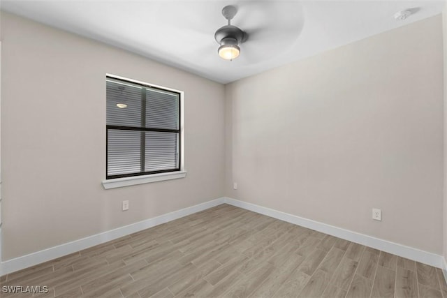 empty room with ceiling fan and light hardwood / wood-style floors