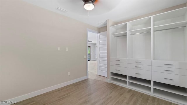 unfurnished bedroom with light wood finished floors, baseboards, visible vents, ceiling fan, and a closet