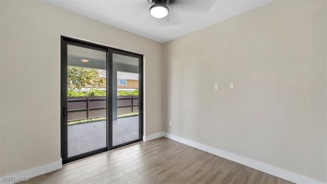 doorway featuring light wood-type flooring and ceiling fan