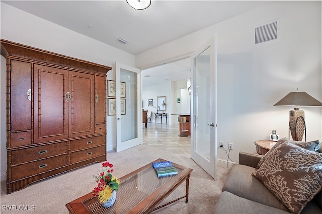 living room featuring light carpet and french doors