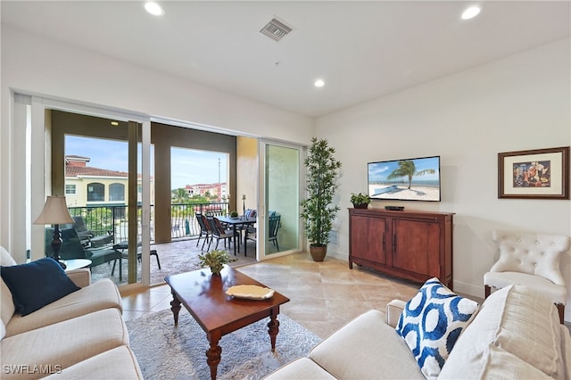 living room featuring a healthy amount of sunlight and light tile patterned flooring