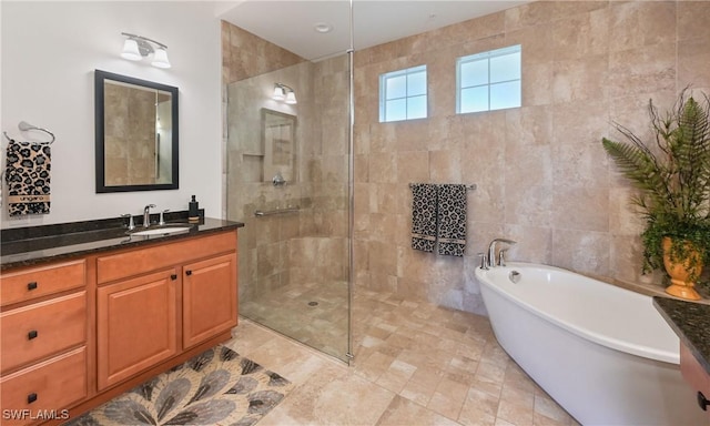 bathroom featuring vanity, tile walls, and plus walk in shower