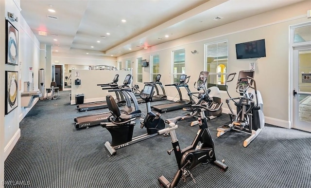 workout area featuring a tray ceiling