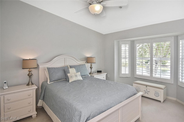 bedroom featuring ceiling fan and light carpet