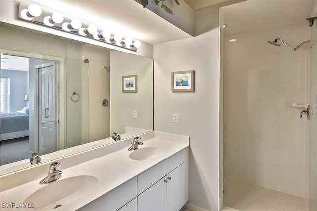 bathroom featuring a tile shower and vanity