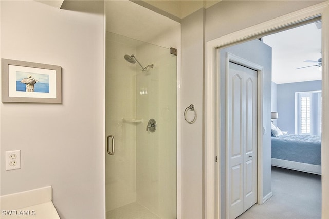 bathroom with an enclosed shower and ceiling fan