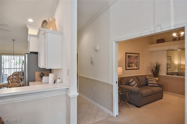 interior space featuring light tile patterned floors, ornamental molding, and sink