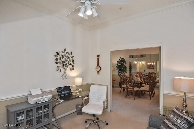 carpeted home office featuring ceiling fan with notable chandelier and ornamental molding